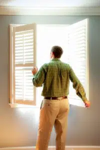 6 clever ways to increase the value of your Clarksville home, A man opening some window shades.