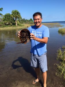 Clarksville TN Realtor Ron Dayley holding a horseshoe crab.