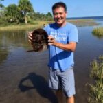 Clarksville TN Realtor Ron Dayley holding a horseshoe crab. Ron has been Rated #4 in the state of TN. Your Clarksville TN Realtor, Ron Dayley